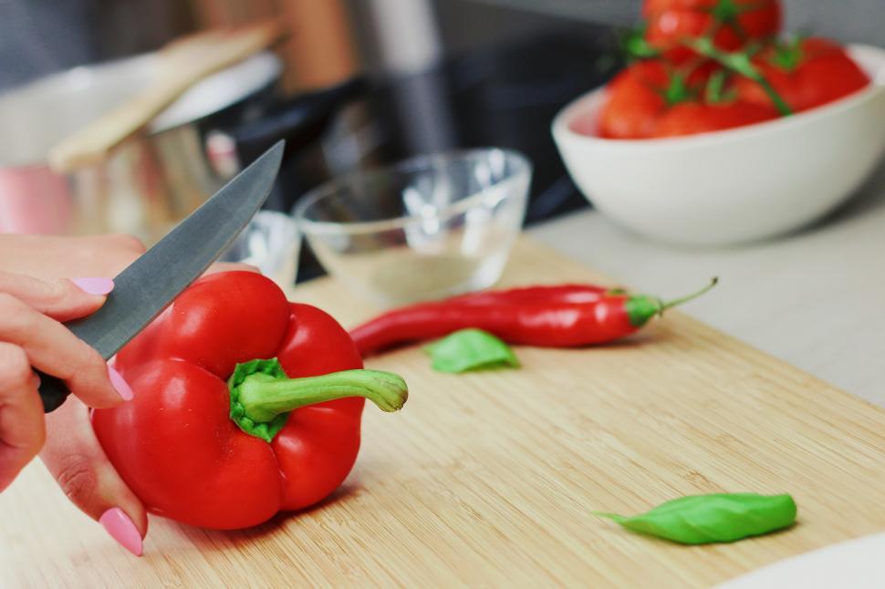Free Image of Person Cutting Up a Red Pepper 