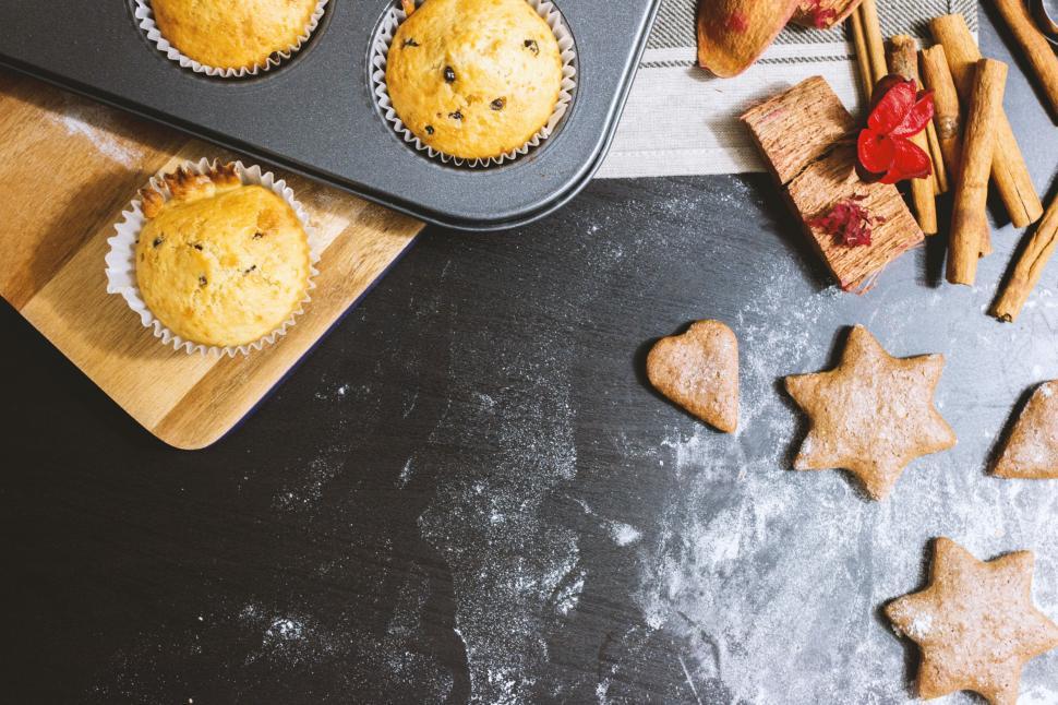 Free Image of Muffin Tin Filled With Muffins, Cookies, and Cinnamon Sticks 