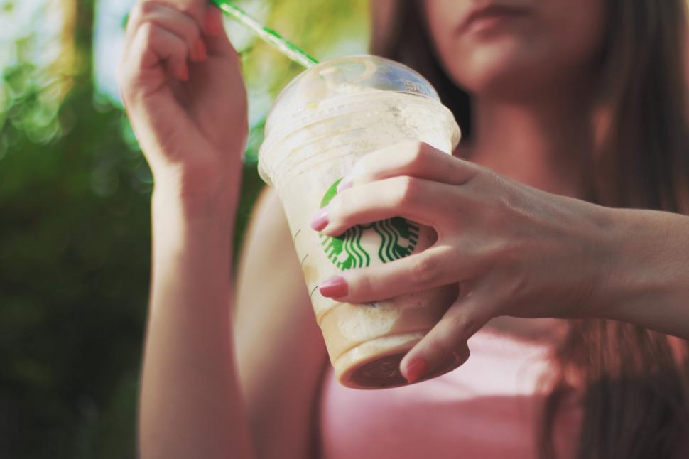 Free Image of Woman Holding Starbucks Drink 
