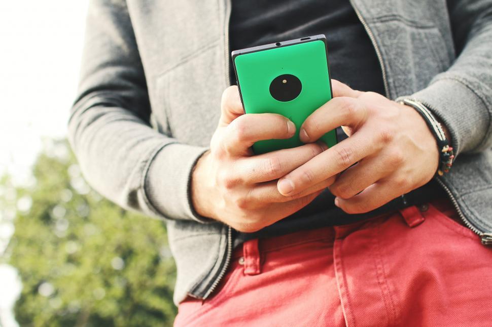 Free Image of Boy with Green Cellphone 