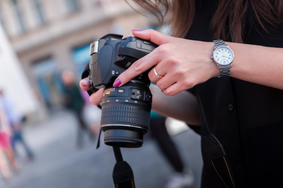 Free Image of Woman Holding Camera and Taking Picture 