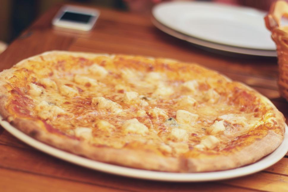 Free Image of Pizza on White Plate on Wooden Table 