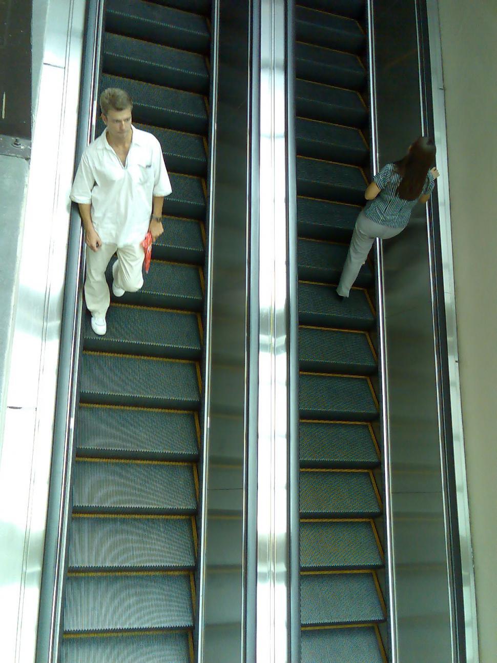 Free Image of two people on escalator 