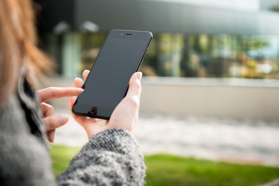 Free Image of Woman Holding Smartphone 
