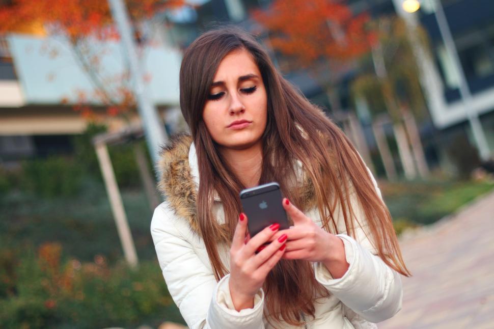 Free Image of Woman Looking at Cell Phone 