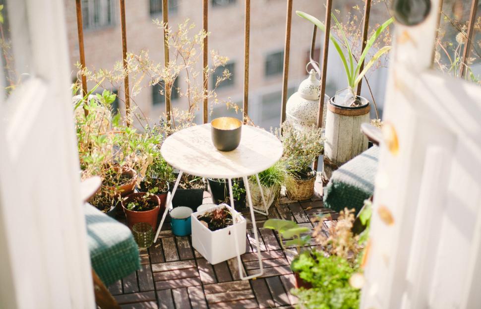 Free Image of Balcony With Potted Plants and Small Table 