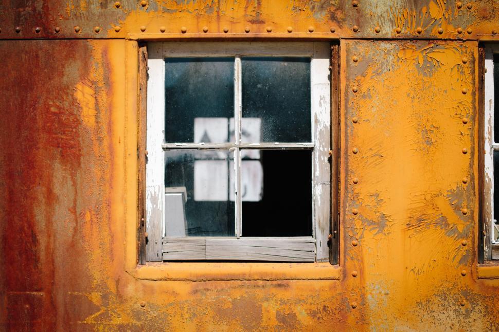 Free Image of Abandoned Rusted Building With Window and Bars 