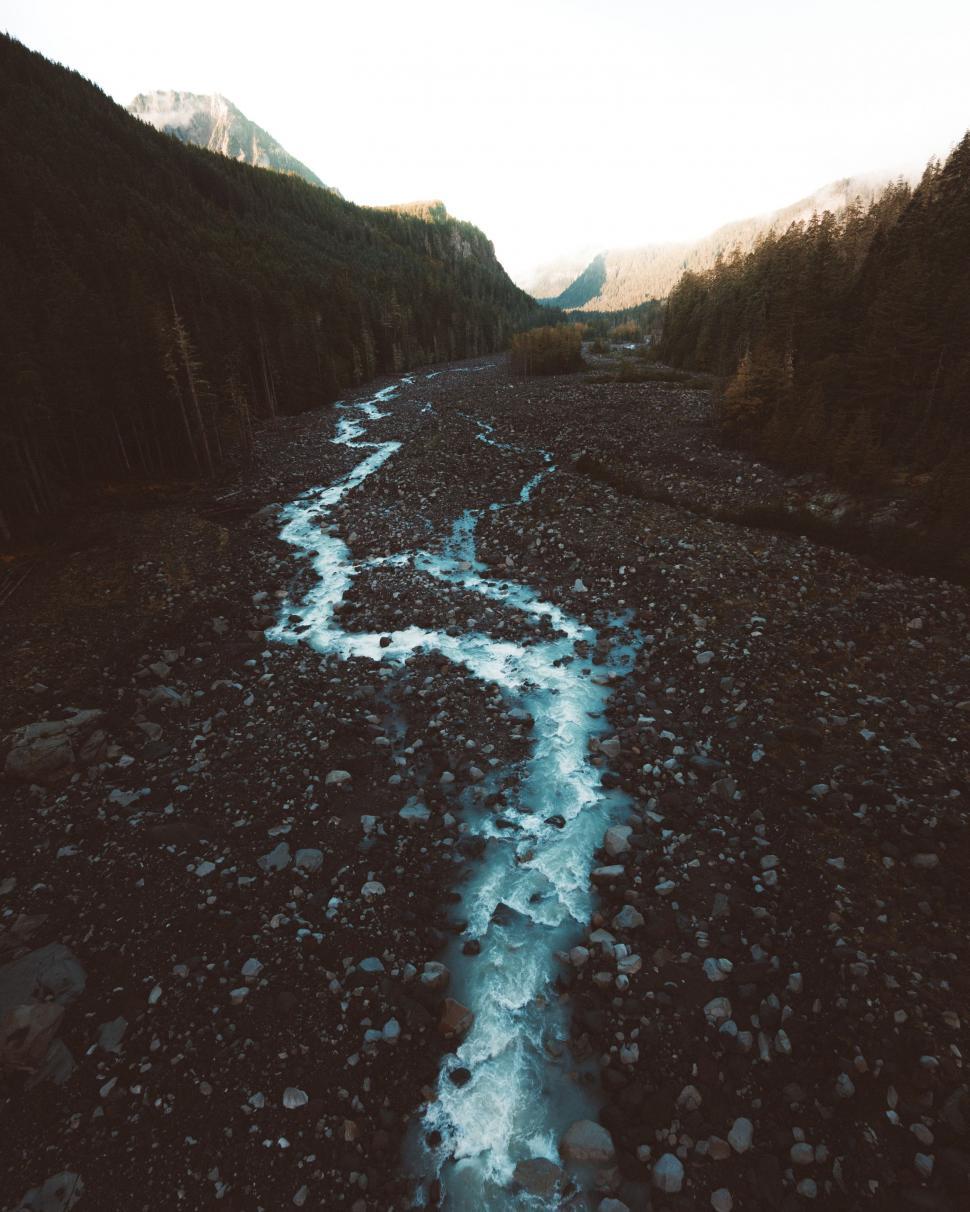 Free Image of River Flowing Through Rocky Forest 