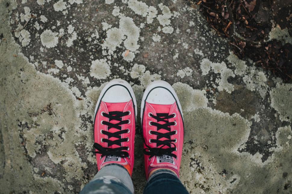 Free Image of Person With Pink Shoes Standing on a Rock 