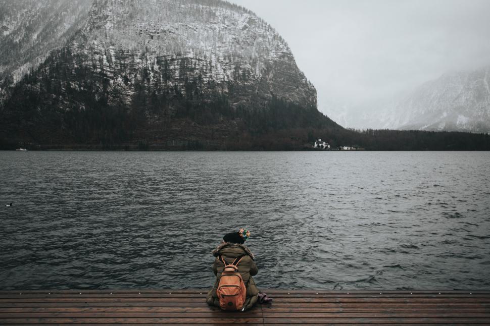 Free Image of Person Sitting on Dock by Water 