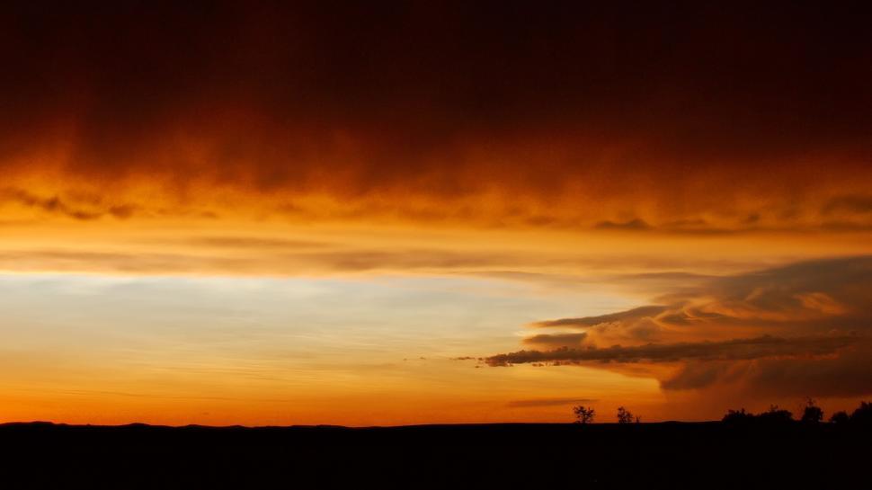 Free Image of Orange Sky With Distance Clouds 
