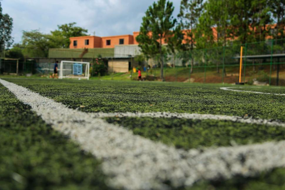 Free Image of Soccer Field With Goal and Building in the Background 
