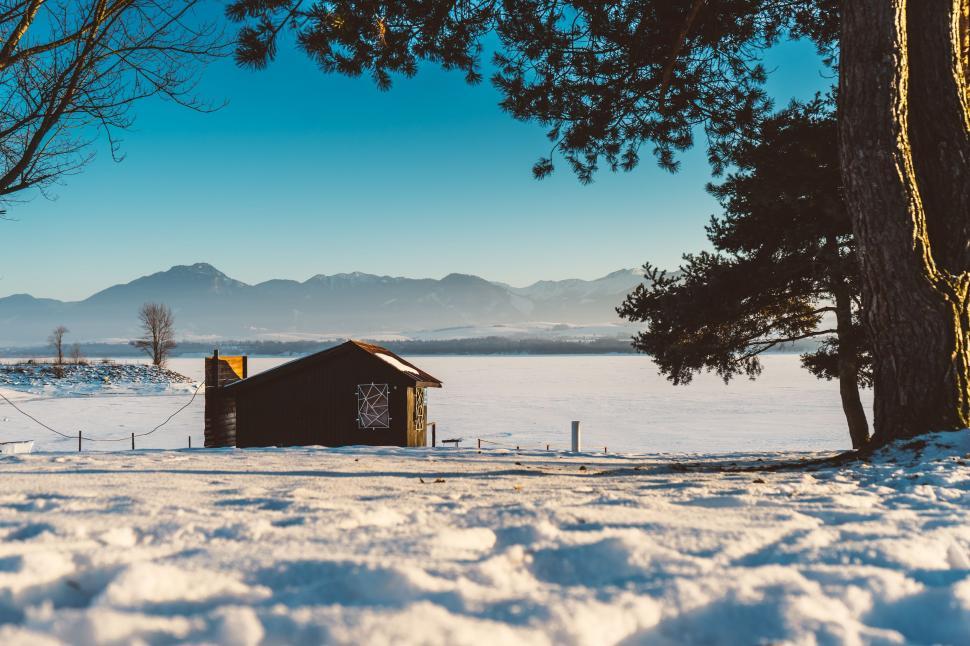 Free Image of Small Cabin in Snowy Field 