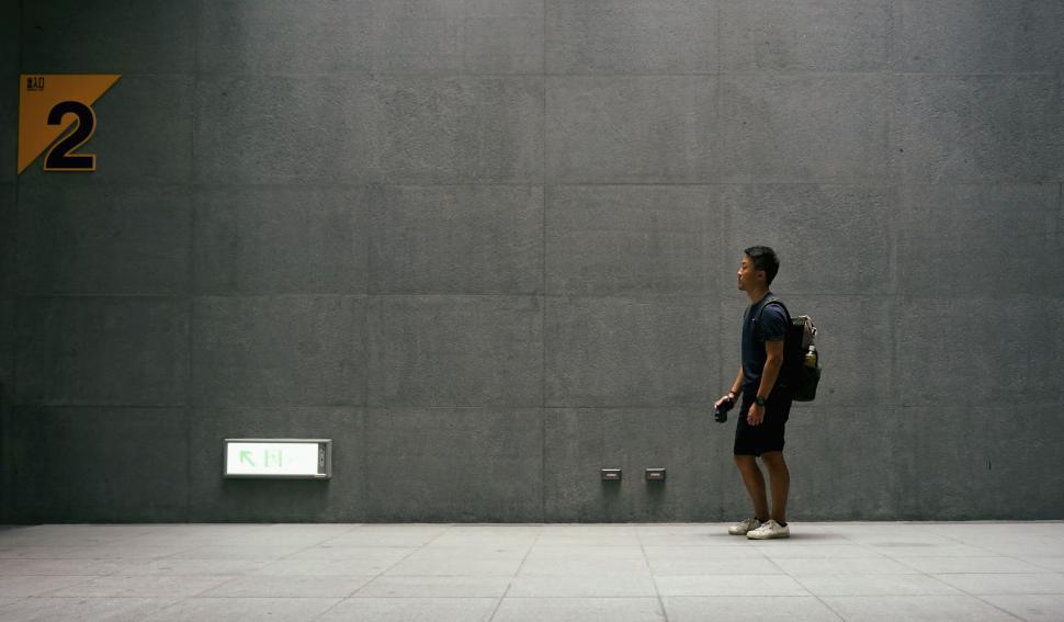 Free Image of Man Standing in Front of Cement Wall 