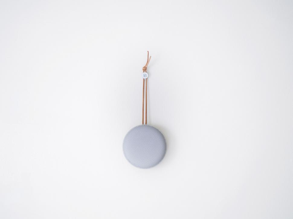 Free Image of Small Round Object Hanging From White Wall 