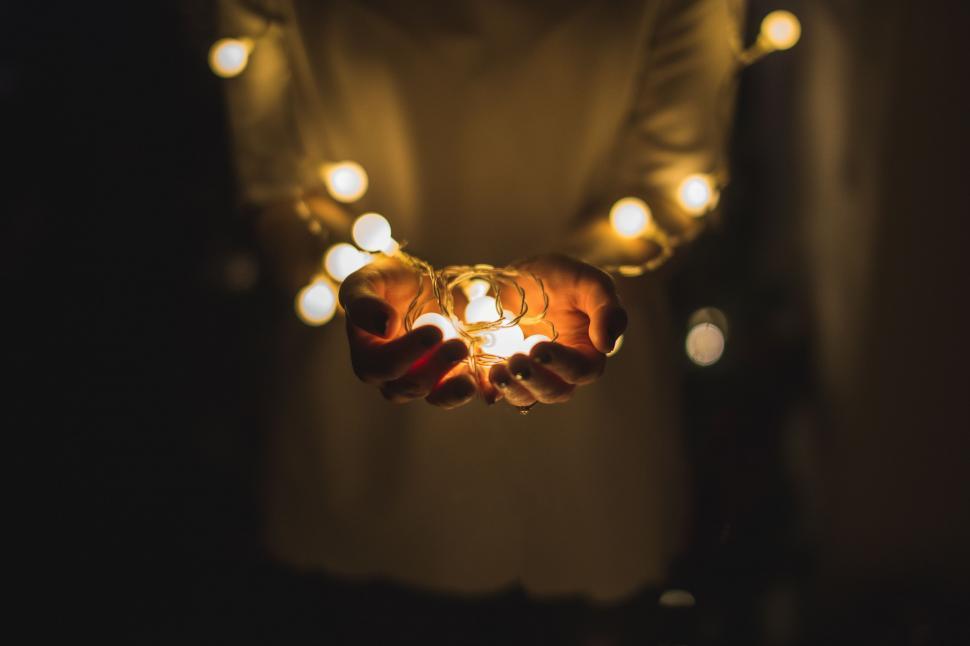 Free Image of Person Holding String of Lights 
