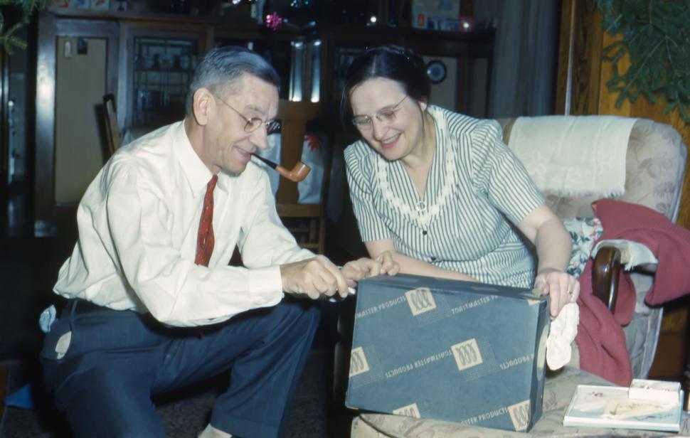 Free Image of Man and Woman Holding a Suitcase 