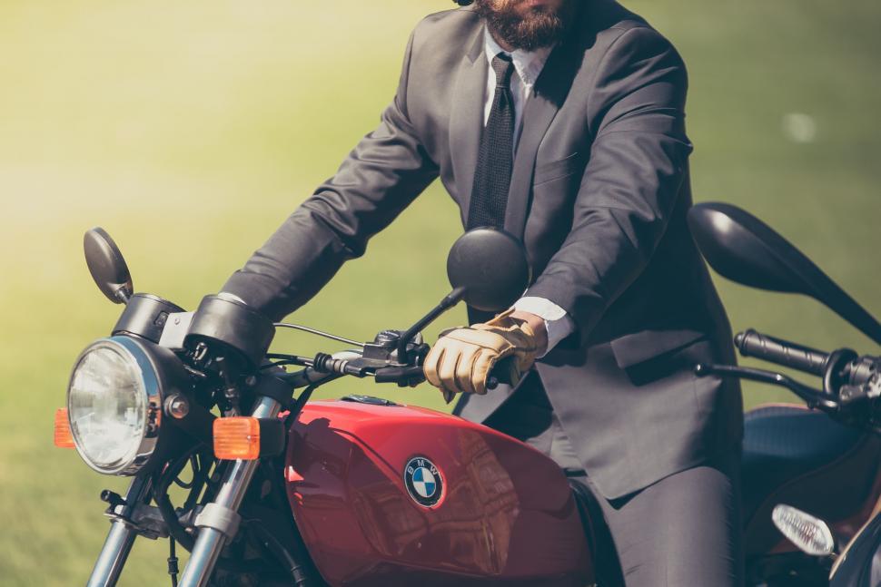 Free Image of Man in Suit and Tie Sitting on Motorcycle 