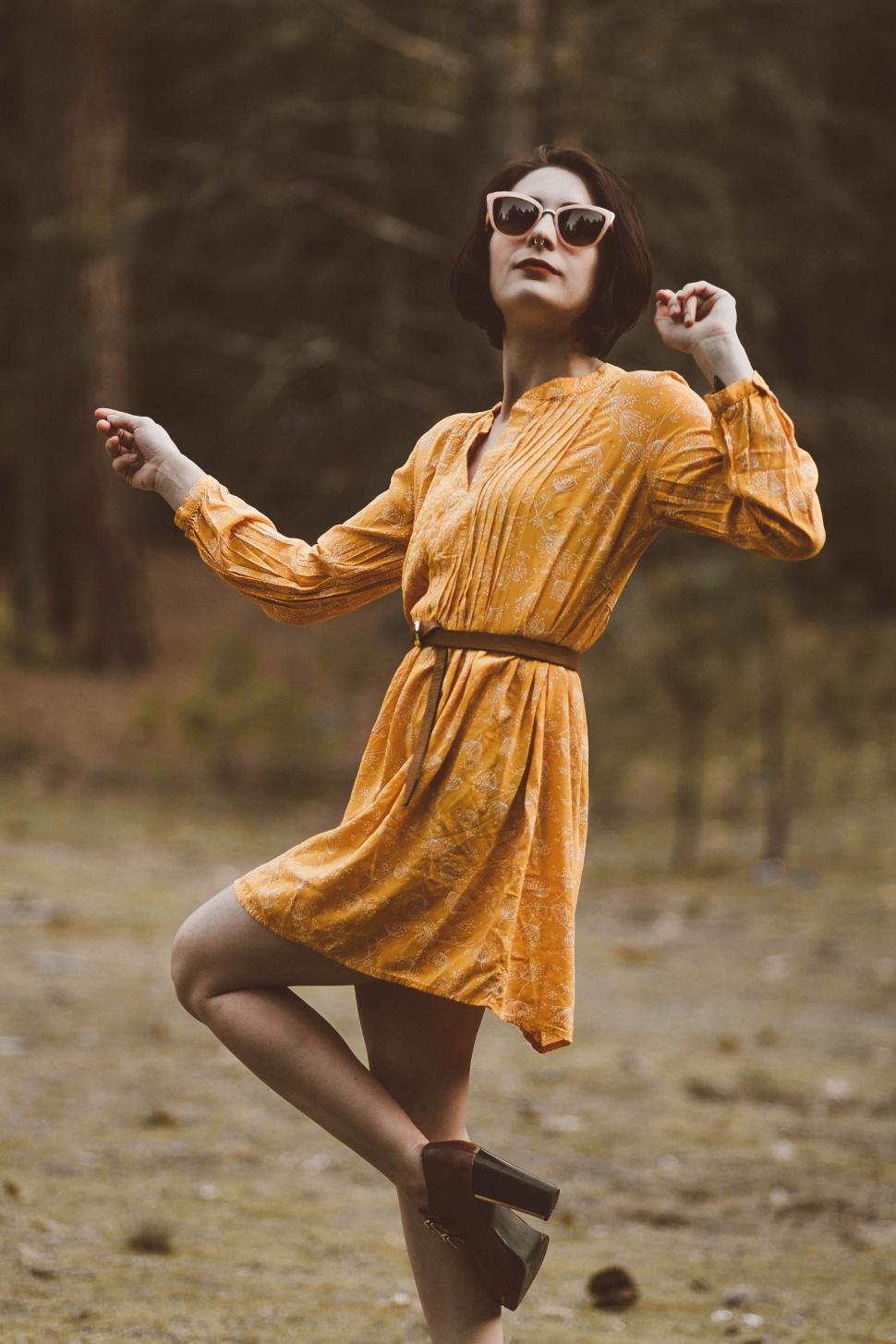 Free Image of Woman in Yellow Dress Dancing 