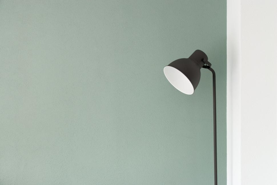 Free Image of Black and White Floor Lamp Against Green Wall 