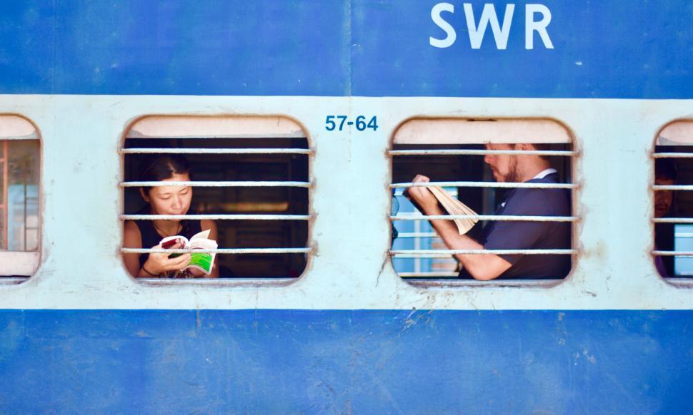 Free Image of People Sitting in Window on Train 