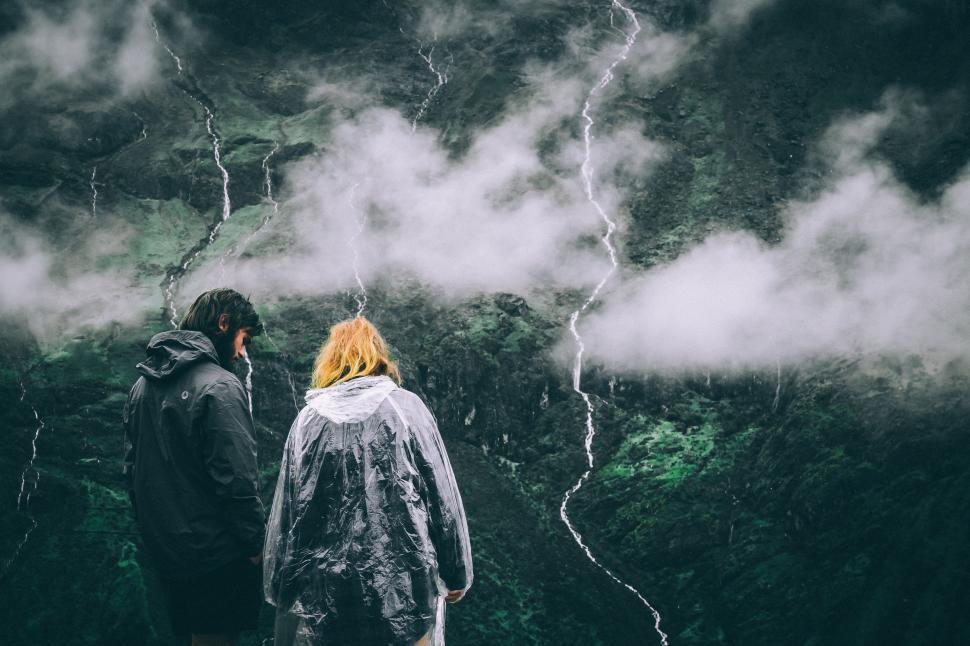 Free Image of Man and Woman Standing in Front of Storm 