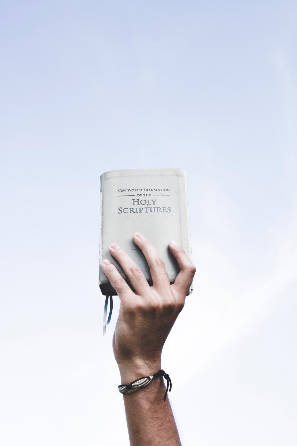Free Image of Person Holding Up a Book in the Air 