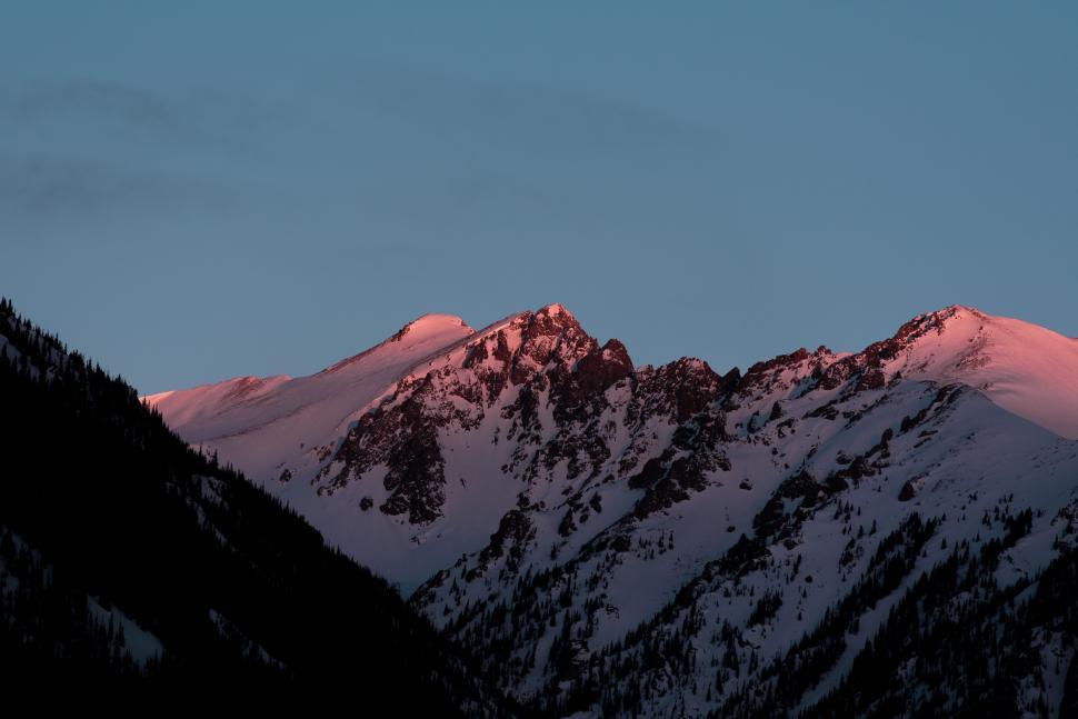 Free Image of Majestic Mountain Range Silhouetted Against the Setting Sun 