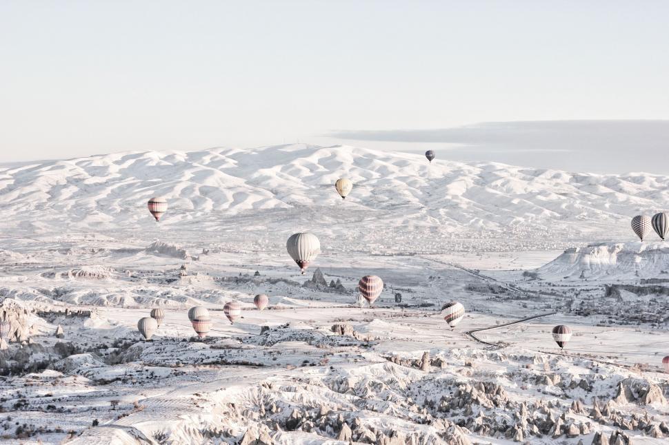 Free Image of Hot Air Balloons Flying Over Snow Covered Field 