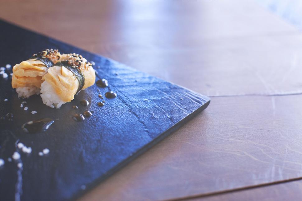 Free Image of Piece of Food on Blue Cutting Board 
