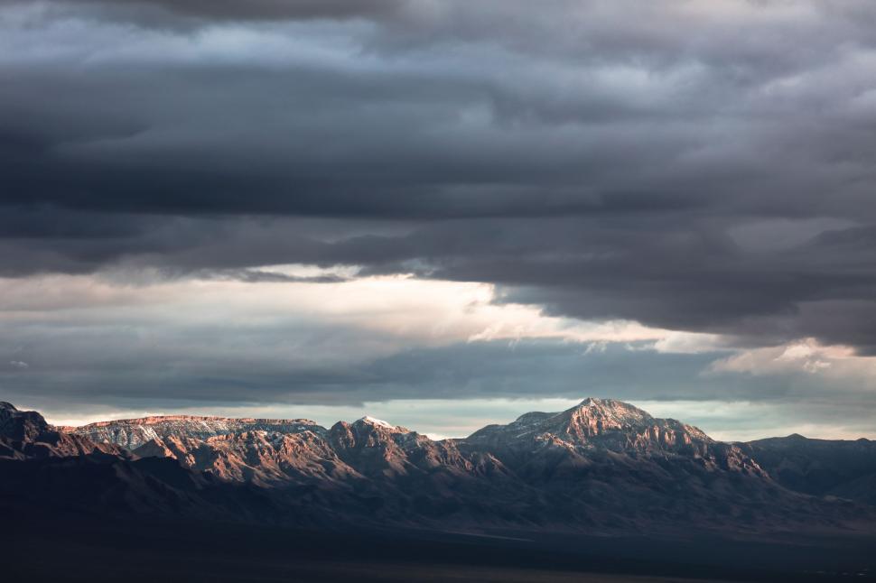 Free Image of Mountain Range Under Cloudy Sky 