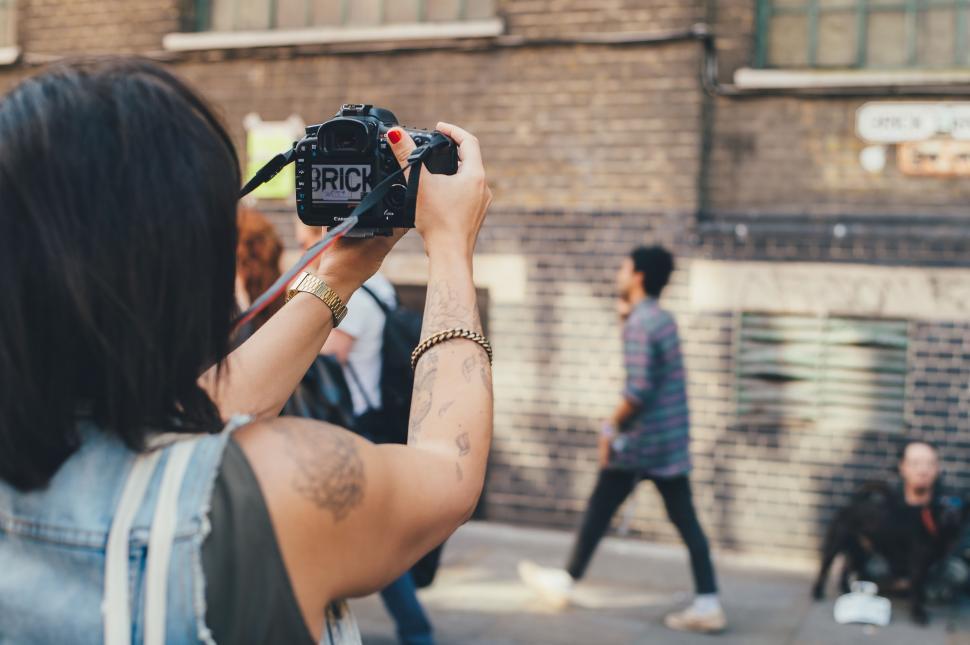 Free Image of Woman Taking Picture of Group of People 