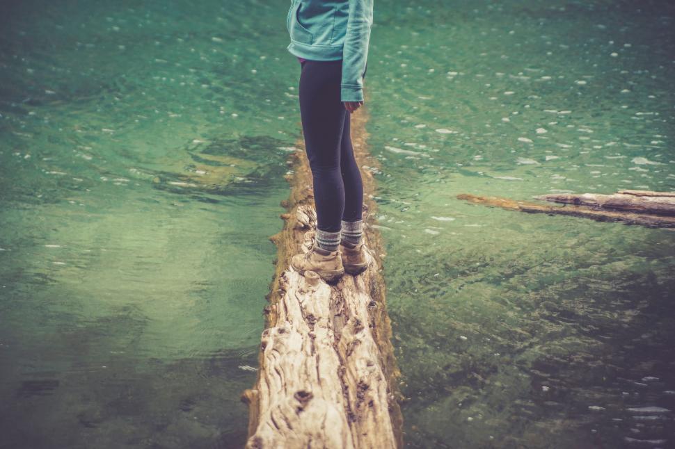 Free Image of Person Standing on Log in Water 