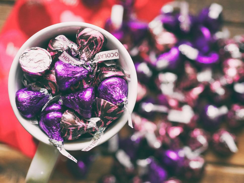 Free Image of White Bowl Filled With Purple and White Chocolate Candies 