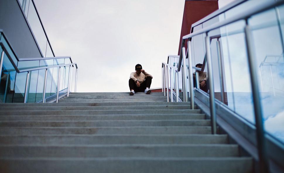 Free Image of Person Sitting on Steps of Building 