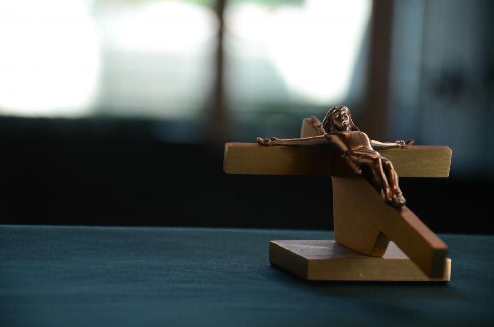 Free Image of Crucifix on Table With Blurry Background 