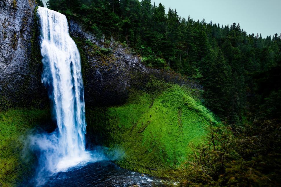 Free Image of Majestic Waterfall in Forest Background 