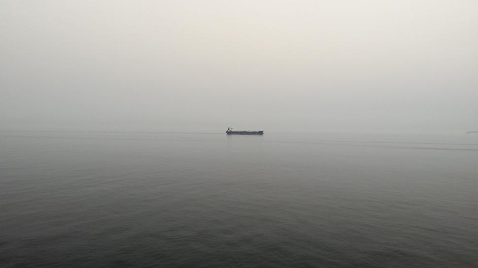 Free Image of Boat Sailing Through Foggy Waters 