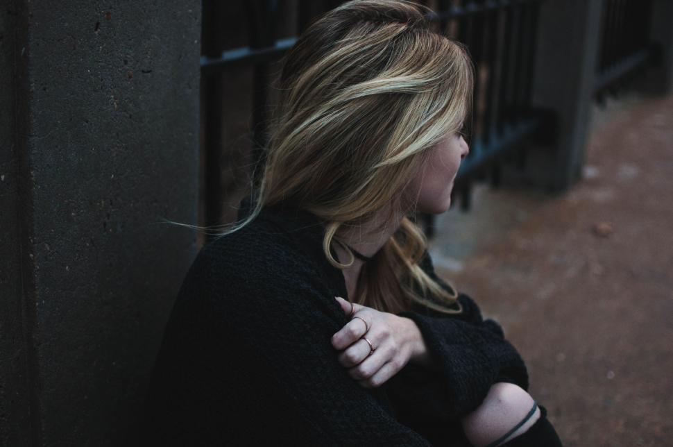 Free Image of Woman Leaning Against Wall 