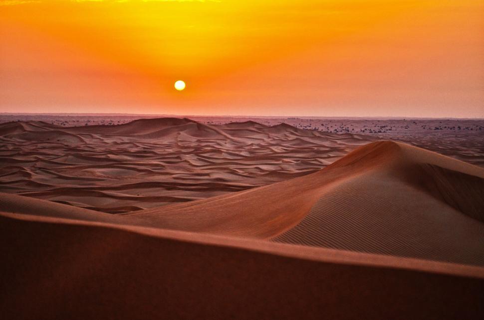Free Image of Sun Setting Over Water in Desert 