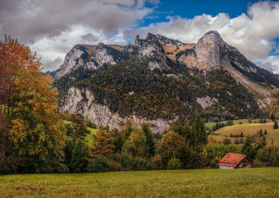Free Image of Mountain Range With Cabin in Foreground 