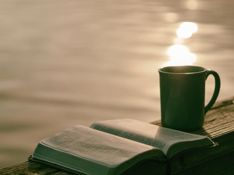 Free Image of A Cup of Coffee and a Book on a Dock 