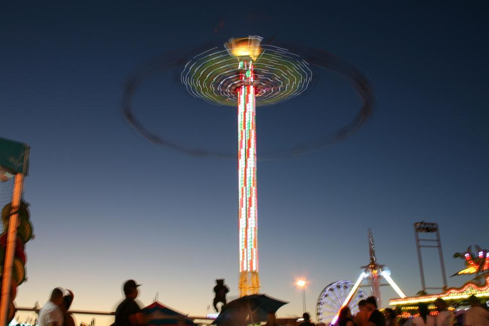 Free Image of Group of People Standing Around Carnival Ride 