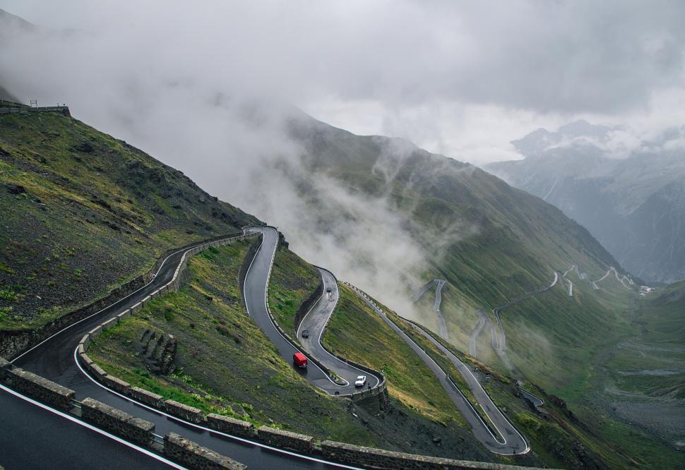Free Image of Car Driving Down a Winding Mountain Road 