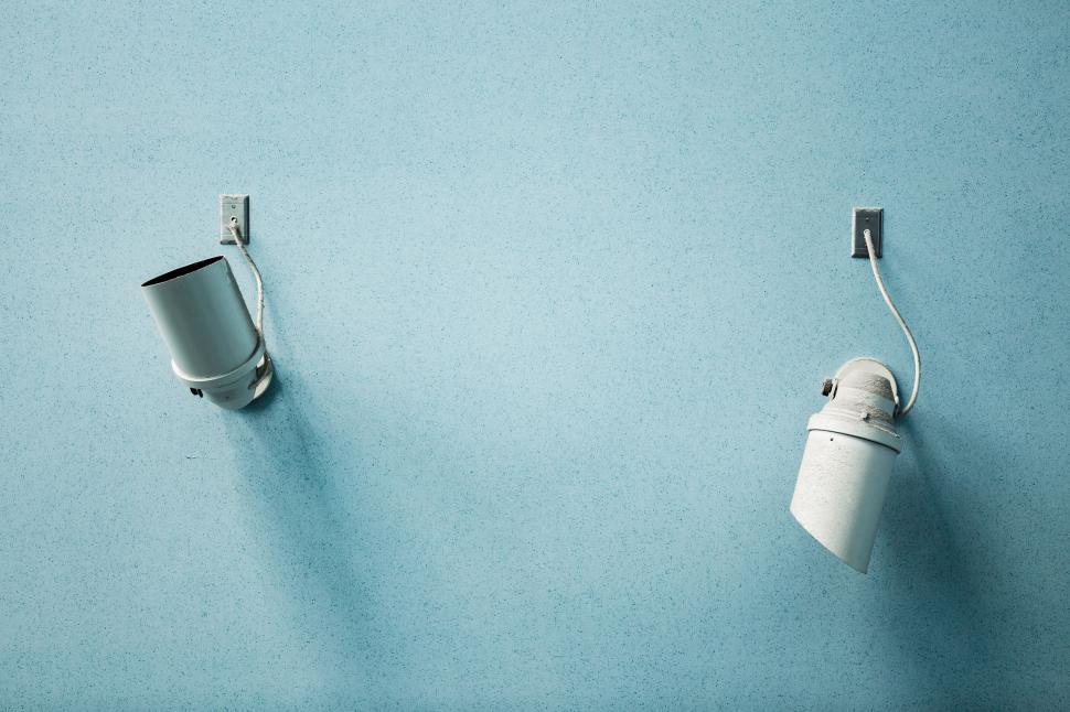Free Image of Two Toilet Paper Rolls Hanging on a Blue Wall 
