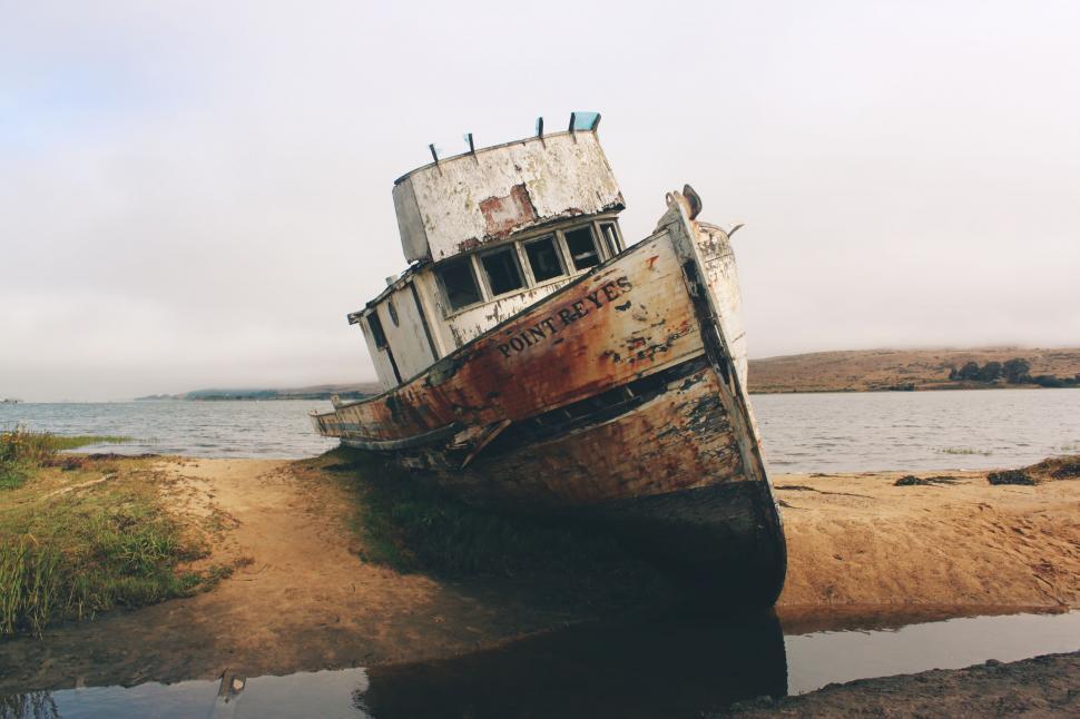 Free Image of Rusted Boat Abandoned on Sandy Beach 