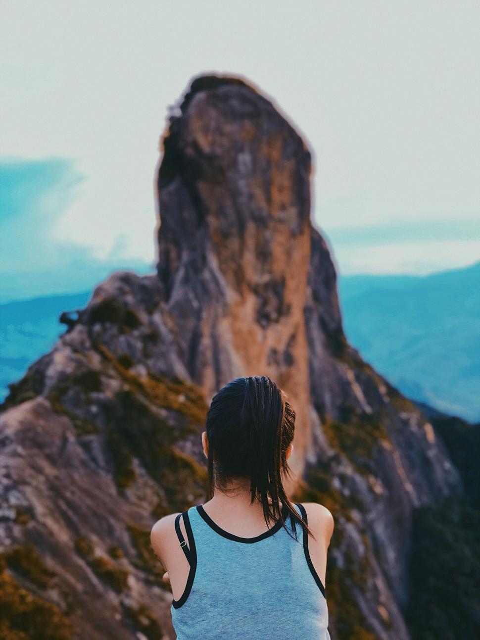 Free Image of Woman Standing on Top of a Mountain 