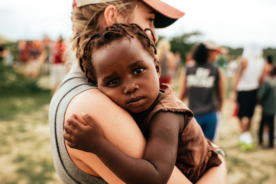 Free Image of Woman Holding Small Child in Her Arms 