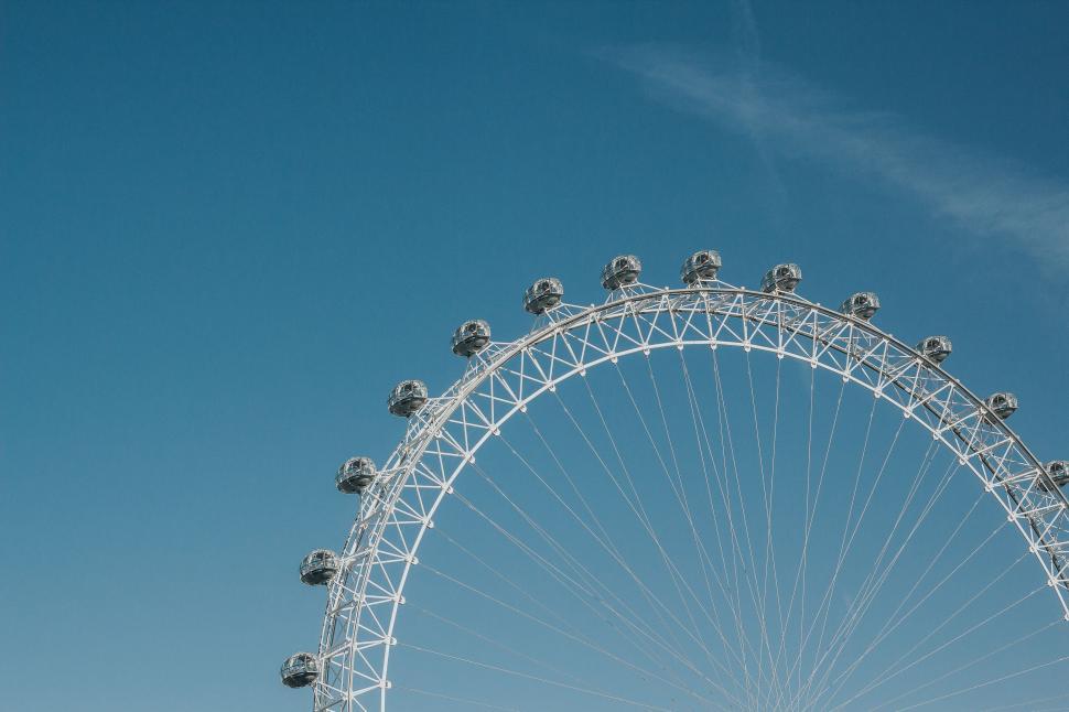 Free Image of Iconic Ferris Wheel Stands Tall Against Clear Blue Sky 