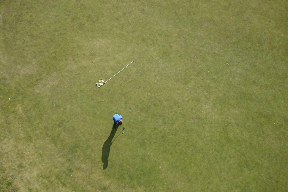 Free Image of Man Golfing on Aerial View of Golf Course 